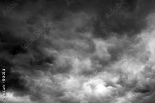 blured background of storm clouds before heavy rain storm for background used , The sky is covered all by black the clouds,