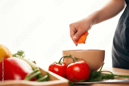 slicing carrots on a cutting board with a knife fresh vegetables cooking