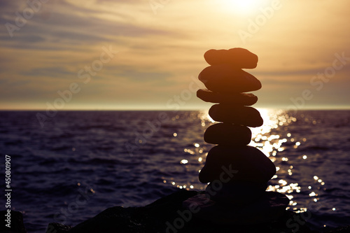 Photography Zen stones on a ocean sea cliff in sunset sunrise time.