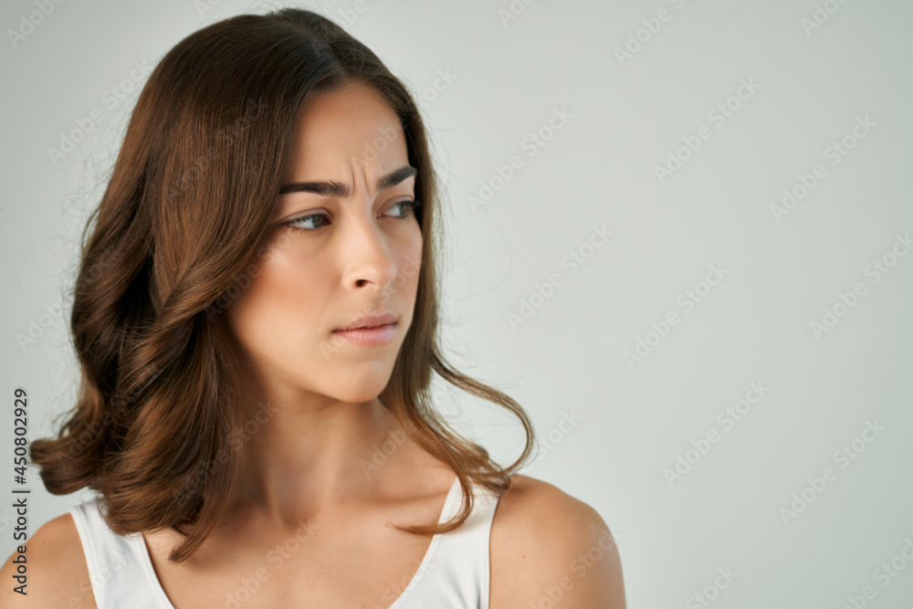 woman in white t shirt emotion displeased facial expression studio isolated background woman in white t shirt emotion displeased facial expression studio isolated background