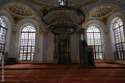 Inside the old ottoman Mosque (Cami) in Konya Turkey. Facade and imam reading the quran with mosques huge windows and light coming inside. 24.07.2021. Konya. Turkey