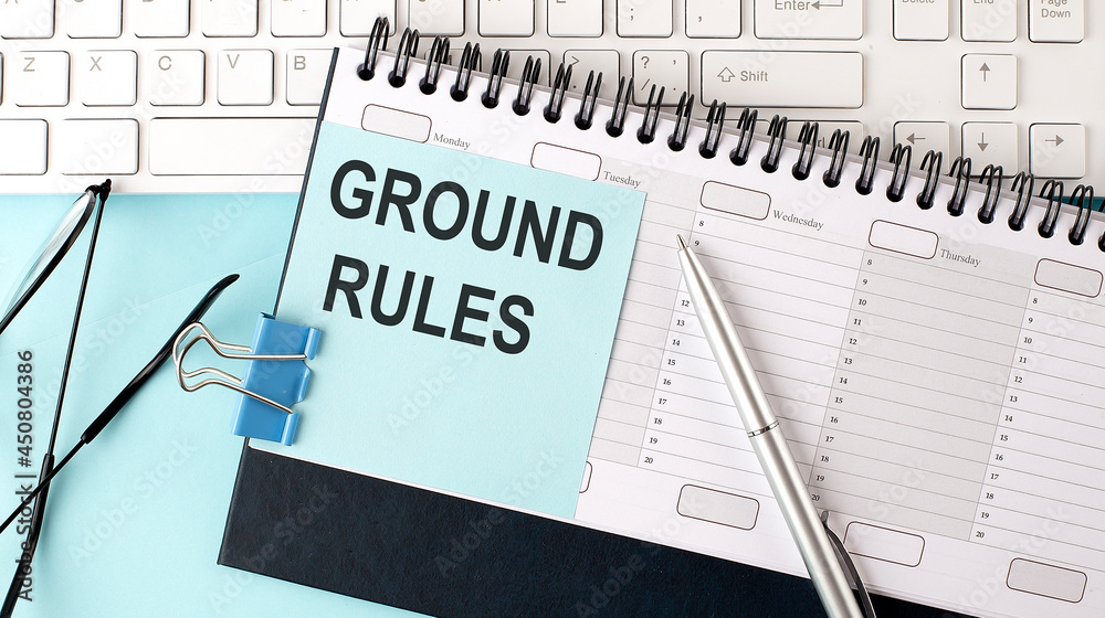 GROUND RULES text on blue sticker on planning and keyboard,blue background