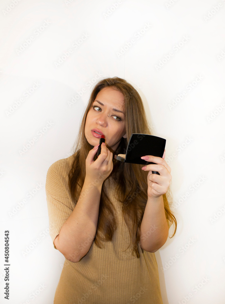 Naklejka premium young beautiful woman with makeup, painted with powder, lipstick, mascara