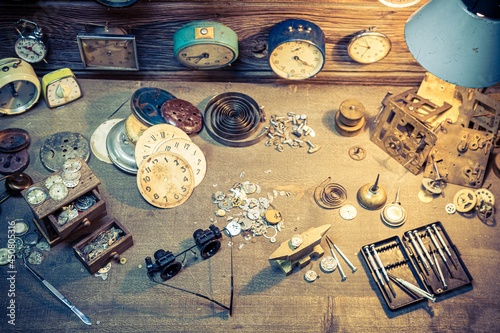 Aged watchmaker's workshop with repaired clocks. Ancient watchmaker's workshop. photo