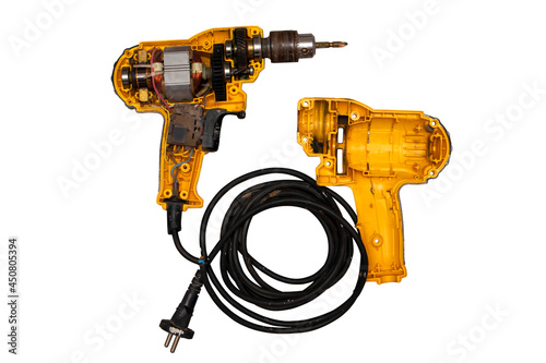 detachable used electric drill on white background The lid opens to reveal the internal components that include the motor, gear and switch.