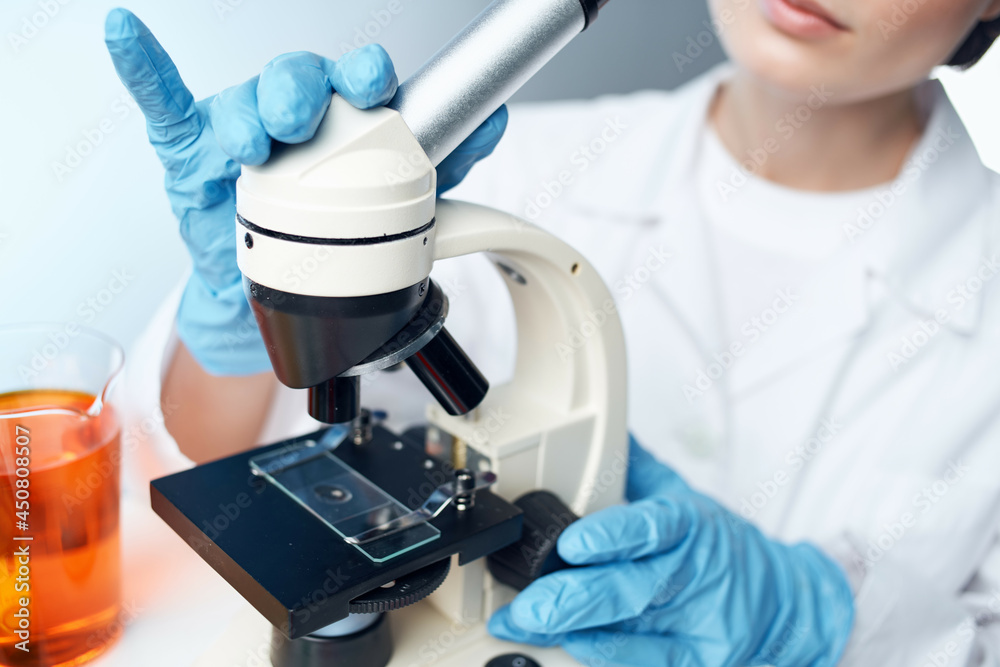female laboratory assistant in a medical gown microscope chemical solutions research female laboratory assistant in a medical gown microscope chemical solutions research
