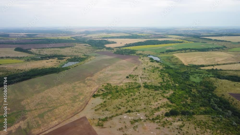 Top view of the fields with ponds.Bird's-eye view of the valley of farm fields. Top view of the fields with ponds.Bird's-eye view of the valley of farm fields.