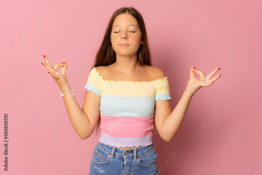 People, yoga and healthy lifestyle. Gorgeous young woman keeping eyes closed while meditating indoors, practicing peace of mind, keeping fingers in mudra gesture People, yoga and healthy lifestyle. Gorgeous young woman keeping eyes closed while meditating indoors, practicing peace of mind, keeping fingers in mudra gesture