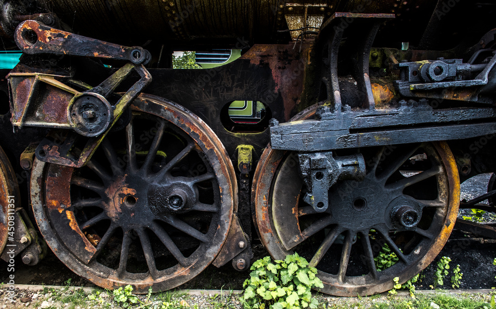 old steam locomotive wheels covered in rust