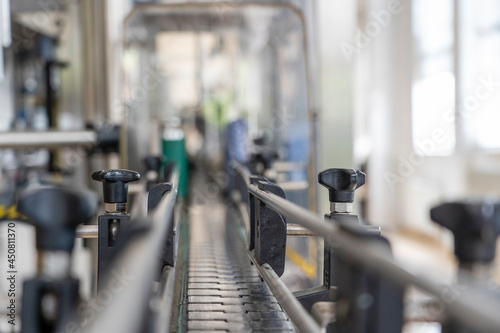 Empty metal conveyor belt for bottling wine at a wine factory, close up, Moldova