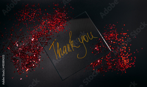 thank you.  Beautiful sparkling text thank you on a black background for a design With Space For Copying Text. A beautiful glowing overlay template for a festive greeting card.