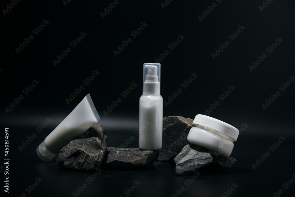 The composition of bottles of cosmetics for face care. A tube of gel, a jar of cream, empty packages without a brand. Advertising of skin care products The composition of bottles of cosmetics for face care. A tube of gel, a jar of cream, empty packages without a brand. Advertising of skin care products
