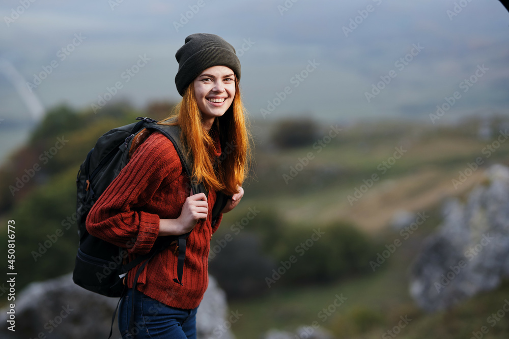 woman hiker with a backpack walks the dog in the mountains in nature woman hiker with a backpack walks the dog in the mountains in nature