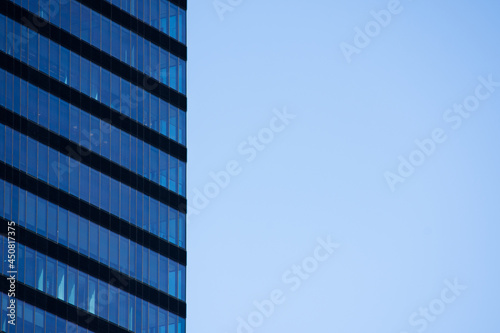 Windows of a skyscraper of Madrid and the blue sky on a sunny day