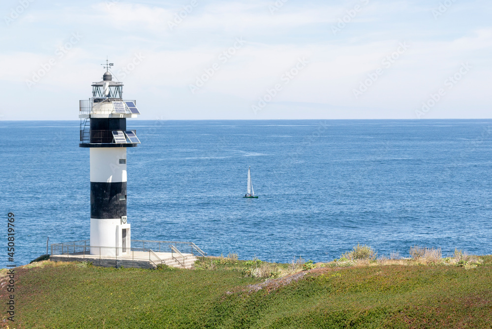 Nice view of the lighthouse of the town of Ribadeo during the day, as one of the most touristic natural environments of Gallicia.
