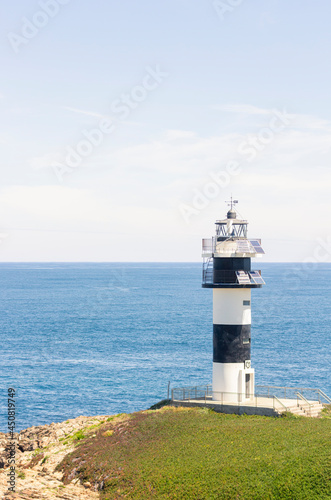 Nice view of the lighthouse of the town of Ribadeo during the day  as one of the most touristic natural environments of Gallicia  vertical shot.