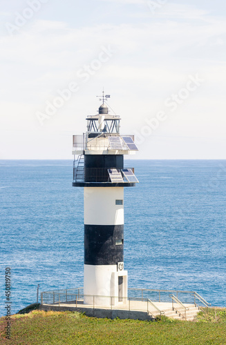 Nice view of the lighthouse of the town of Ribadeo during the day, as one of the most touristic natural environments of Gallicia, vertical shot, close up. photo