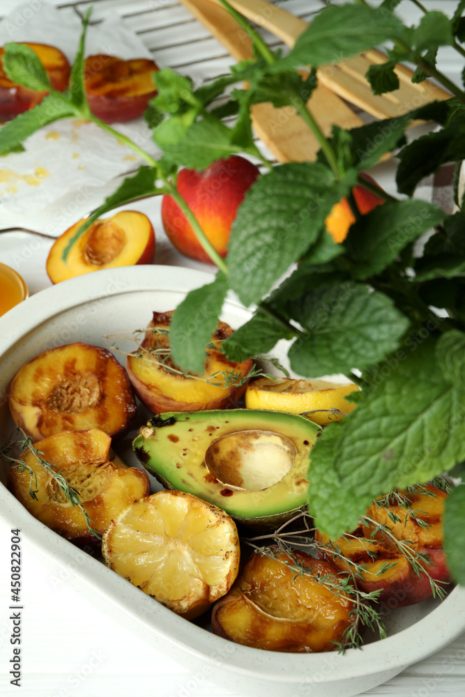 Concept of tasty food with grilled peach on white wooden table Concept of tasty food with grilled peach on white wooden table