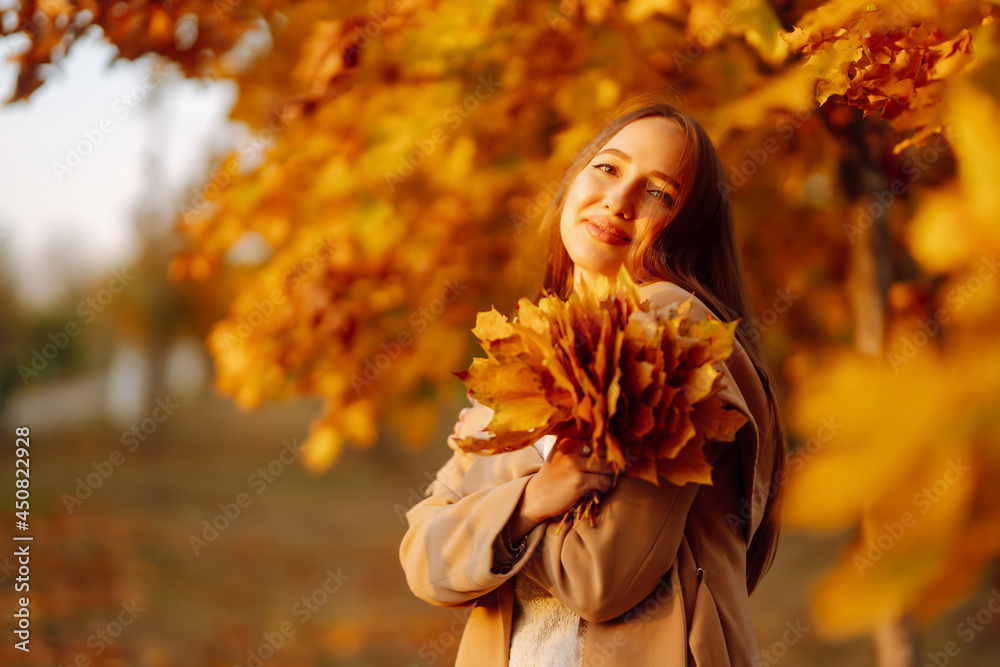 Young woman having fun throwing leaves in autumn at city park. Lifestyle. Relax, nature concept. Autumn mood concept. Young woman having fun throwing leaves in autumn at city park. Lifestyle. Relax, nature concept. Autumn mood concept.