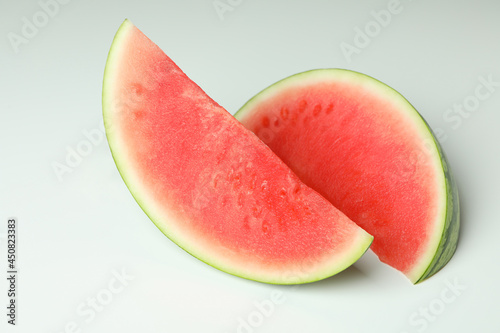 Two juicy watermelon slices on white background