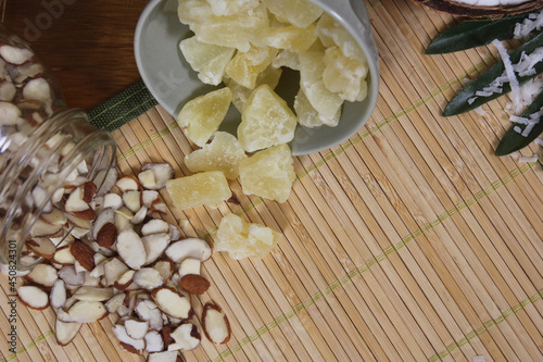 Sliced Almonds and Dried Pineapple on Bamboo Mat Close up