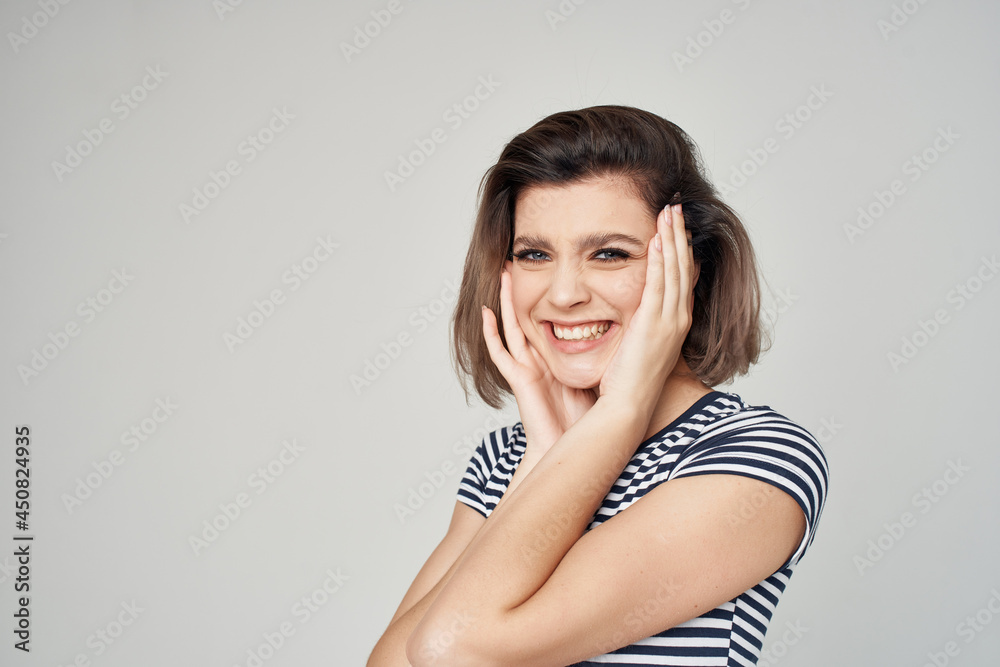 cheerful woman striped t-shirt fashionable clothes posing light background cheerful woman striped t-shirt fashionable clothes posing light background