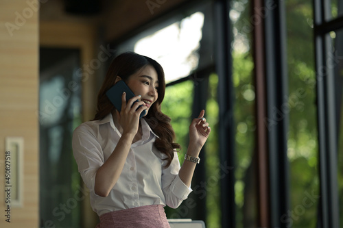 Portrait with businesswoman talking on smartphone.