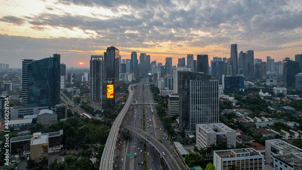 Fototapeta premium Aerial view of Panoramic photo of Jakarta overlooking Parklands, and the city skyline with a spectacular sunset. Jakarta, Indonesia, August 13, 2021