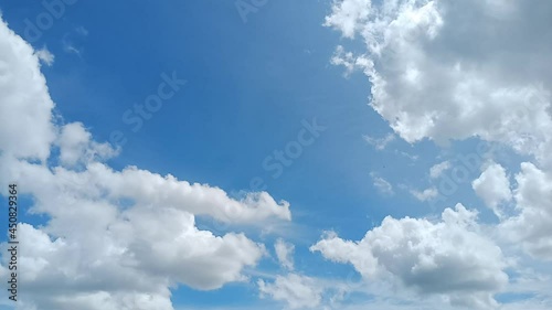 Timelapse of White Cumulus Clouds Changing Shape In Blue Sky With Green Trees