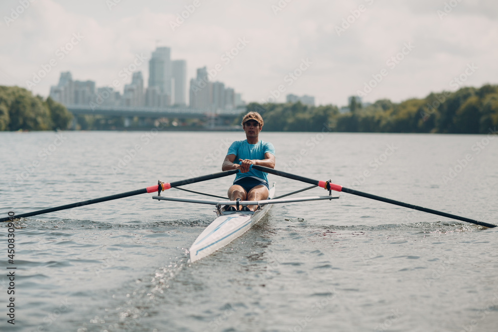 Sportsman single scull man rower rowing on boat. - obrazy, fototapety, plakaty 