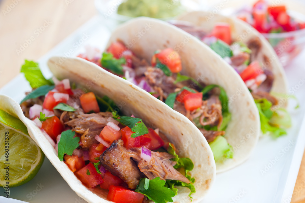 Tacos with pulled pork, tomato salsa and guacamole Tacos with pulled pork, tomato salsa and guacamole