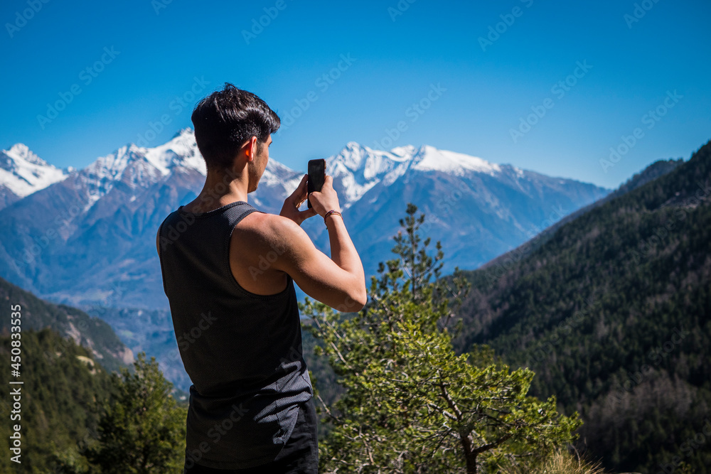 Young man taking photo with cell phone