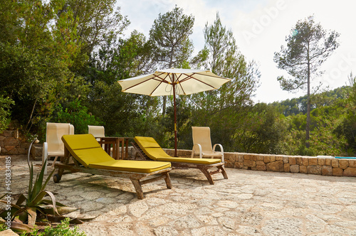 Hammocks and sun umbrella surrounded by nature at a property in Serra de Tramuntana mountain range (Andratx, Majorca, Balearic Islands, Spain)