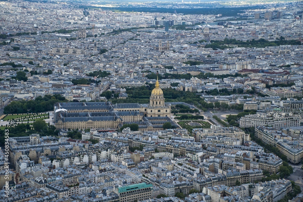 Aerial panoramic view of sprawling city of Paris and its skyline with monuments and buildings.