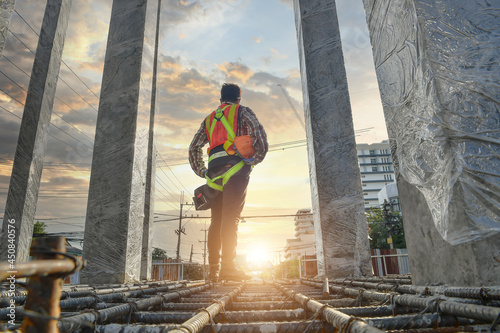 Construction worker wearing safety work at high uniform photo