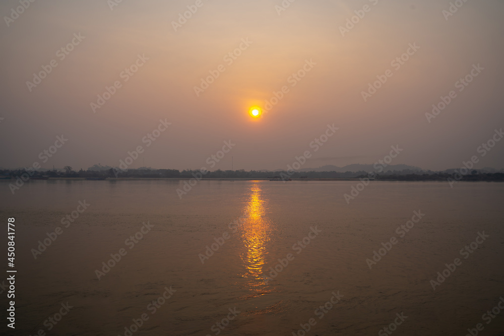 The Sunrise environment at Mekong River, shoot image from Thailand side to Laos country with sunlight reflexion on surface river.