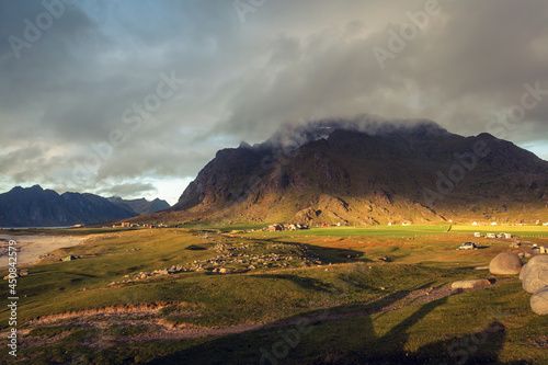 Scenic sunset view on the Unstad village and mountains, Lofoten, Norway