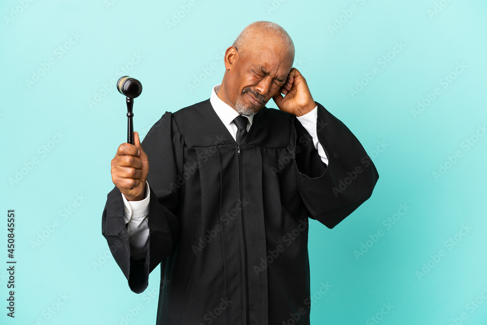 Judge senior man isolated on blue background frustrated and covering ears Judge senior man isolated on blue background frustrated and covering ears