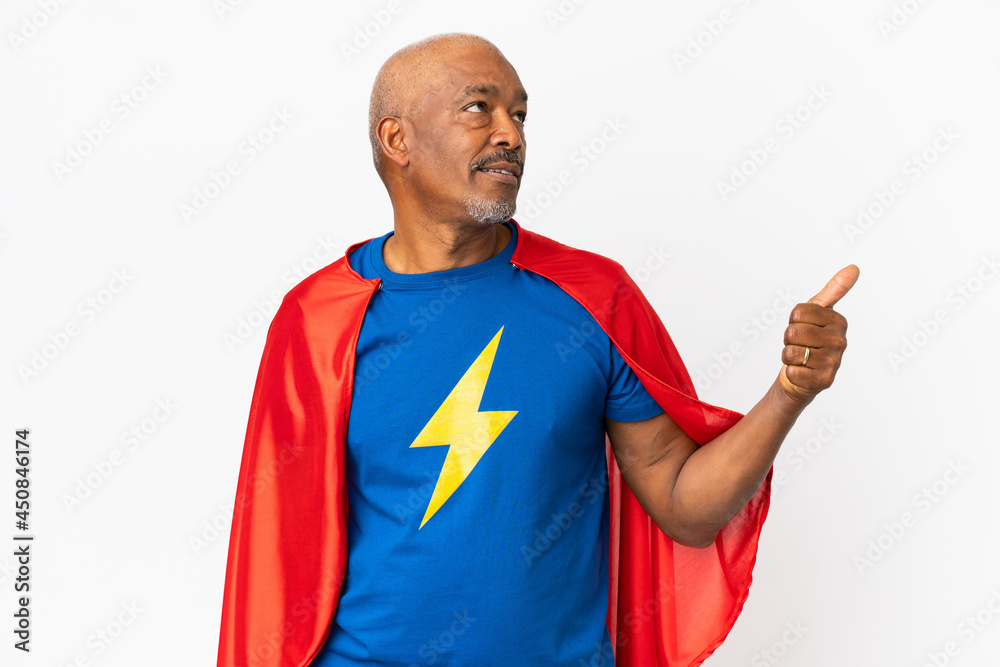 Super Hero senior man isolated on white background pointing to the side to present a product Super Hero senior man isolated on white background pointing to the side to present a product