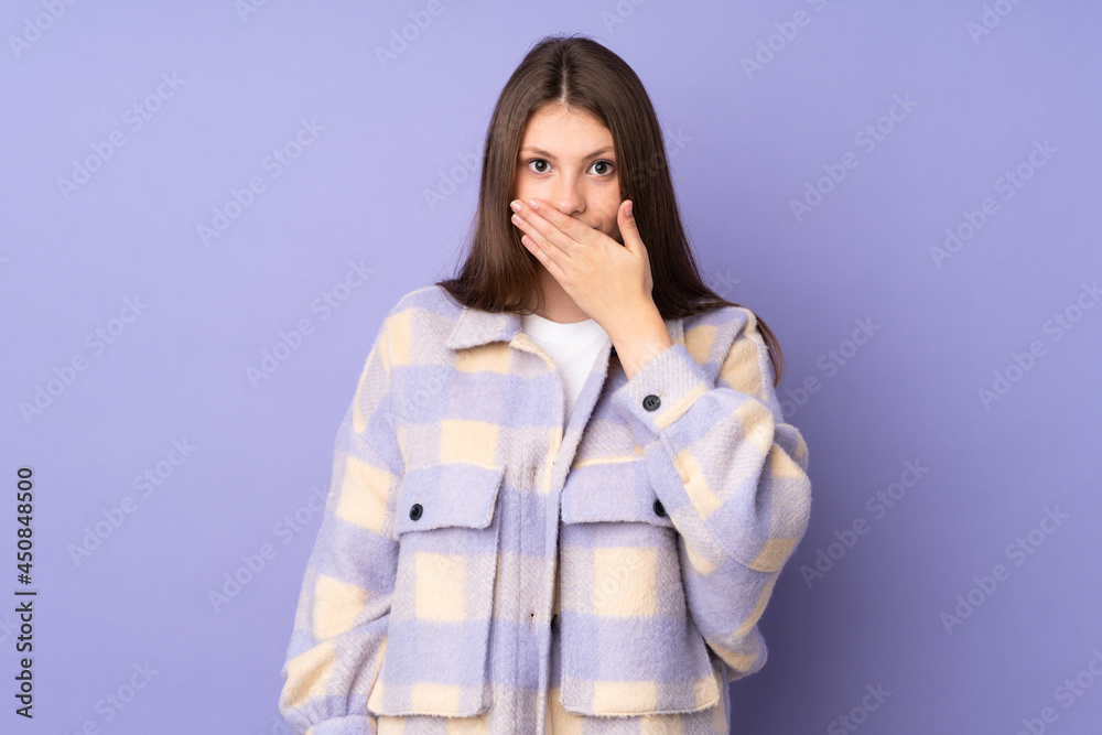 Teenager caucasian girl isolated on purple background covering mouth with hand Teenager caucasian girl isolated on purple background covering mouth with hand