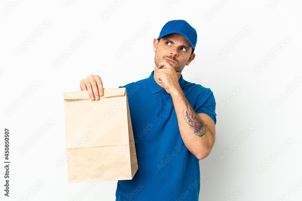 Brazilian taking a bag of takeaway food isolated on white background and looking up Brazilian taking a bag of takeaway food isolated on white background and looking up