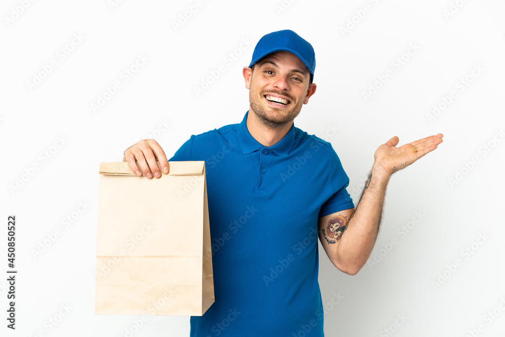 Brazilian taking a bag of takeaway food isolated on white background with shocked facial expression Brazilian taking a bag of takeaway food isolated on white background with shocked facial expression