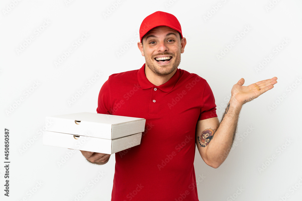 pizza delivery man with work uniform picking up pizza boxes over isolated white wall with shocked facial expression pizza delivery man with work uniform picking up pizza boxes over isolated white wall with shocked facial expression