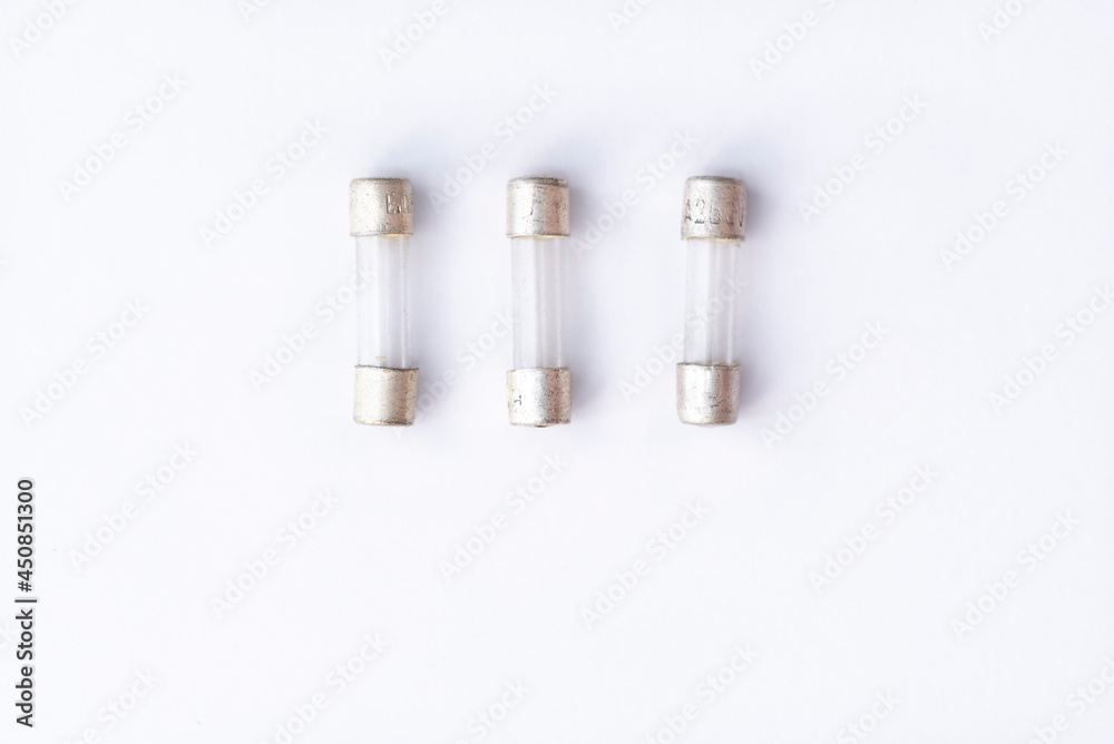 Radio components, old glass fuse on white background. Simple electronics Radio components, old glass fuse on white background. Simple electronics