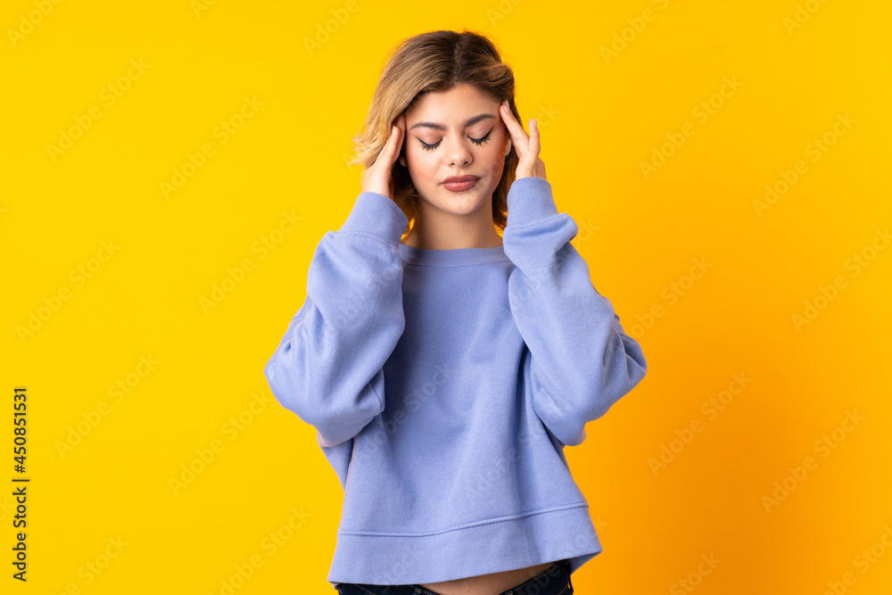 Young Russian woman isolated on yellow background with headache Young Russian woman isolated on yellow background with headache