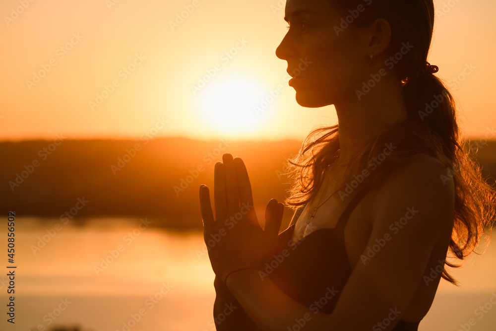 Beautiful woman portrait raise hands and face close up in warm sun light outdoor, yoga meditation practice