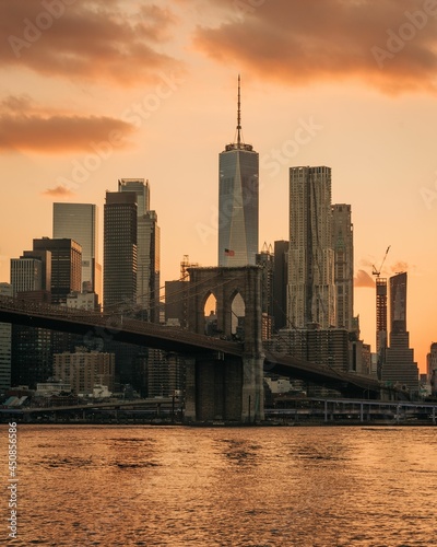 View of the Brooklyn Bridge and Manhattan skyline at sunset, from Dumbo, Brooklyn, New York City © jonbilous