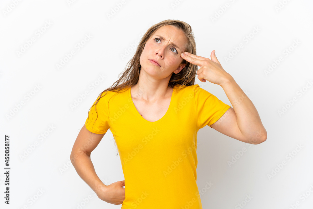 Fototapeta premium Young caucasian woman isolated on white background with problems making suicide gesture