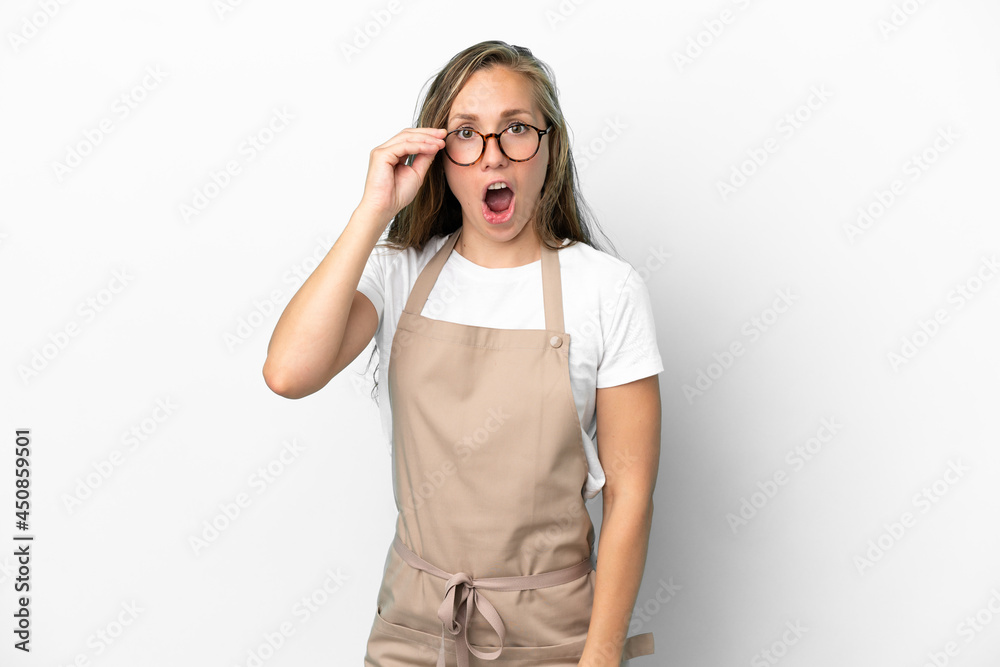 Restaurant waiter caucasian woman isolated on white background with glasses and surprised
