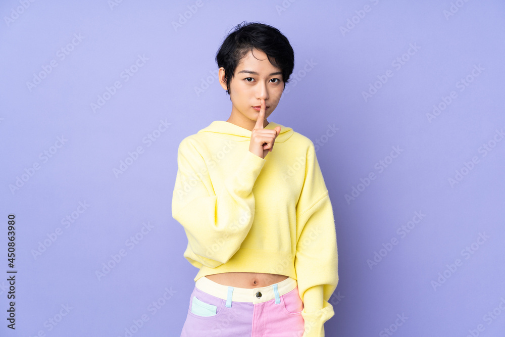Young Vietnamese woman with short hair over isolated purple background showing a sign of silence gesture putting finger in mouth Young Vietnamese woman with short hair over isolated purple background showing a sign of silence gesture putting finger in mouth